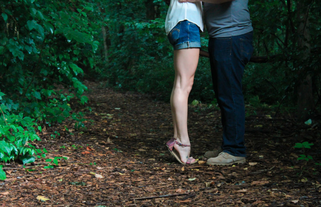 two people kissing on tiptoes in forest only see lower body mosalingua