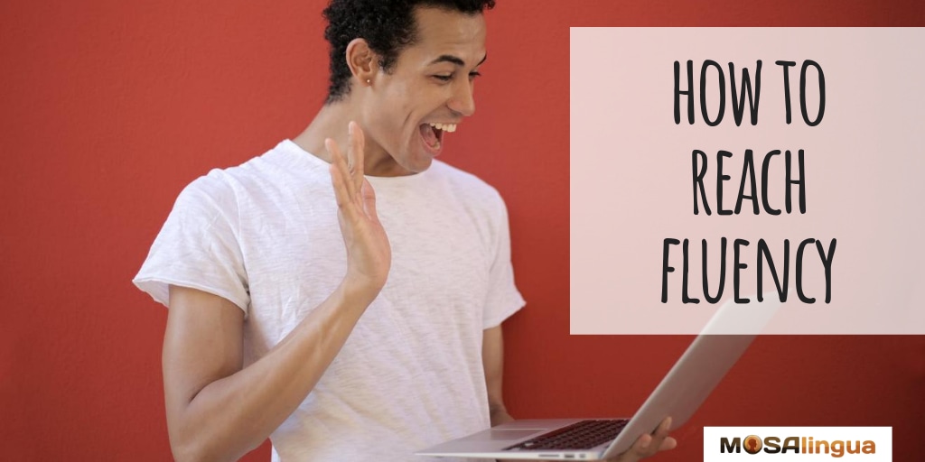 how to reach fluency and become fluent excited person  waving at laptop mosalingua