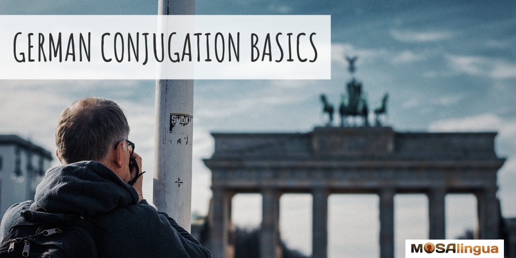 Man photographing Brandenburg Gate in Berlin. Text reads: German conjugation basics MosaLingua